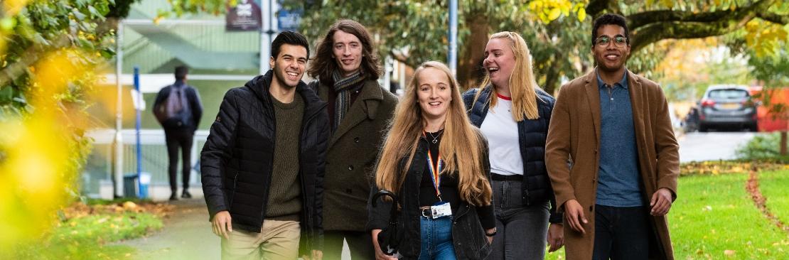 Students walking through leafy campus