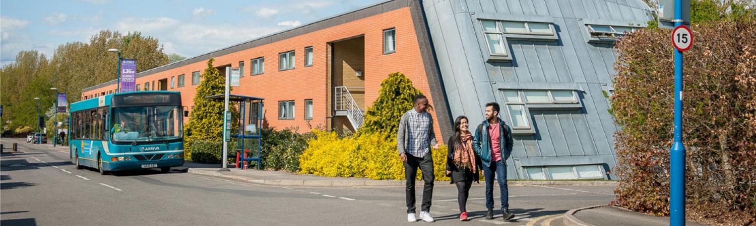 Students walking by Millenium House accommodation