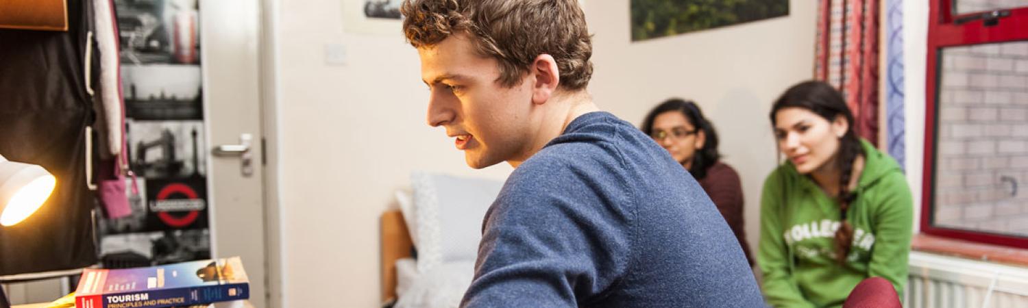 Students sat in University Court accommodation room