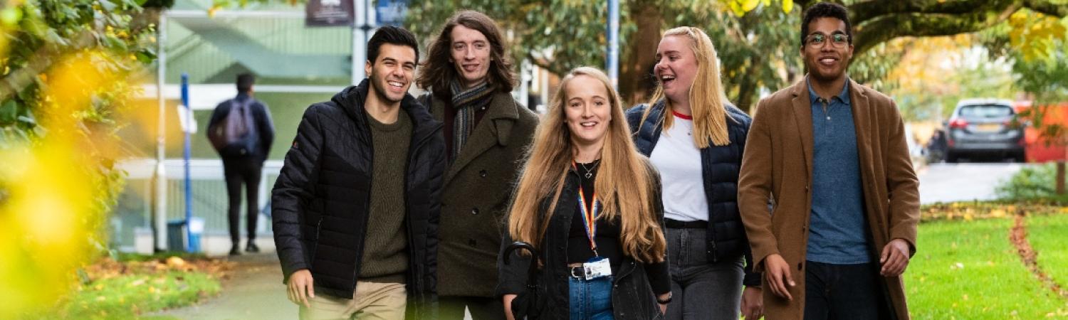 Students walking through leafy campus